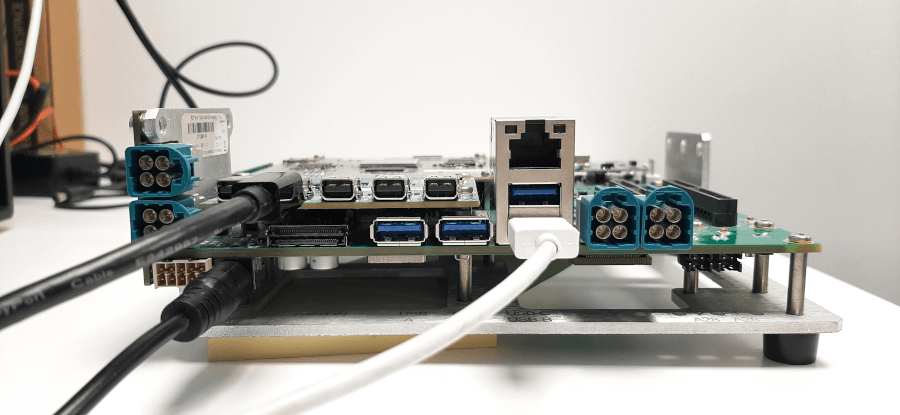 This is a wiring configuration example: power is ON, male USB-A is connected for flashing images, DisplayPort cable is connected for Graphical output. "Front view of the Qualcomm Snapdragon 8155P board."